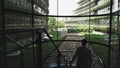 Young ambitious entrepreneur walking up the stairs in a modern office building. Concept of motivated and confident man