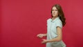 Young ambitious purposeful woman in polo t-shirt pulling invisible rope working