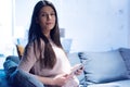 Young American business woman sitting at her sofa, using tablet in her office and smiling Royalty Free Stock Photo