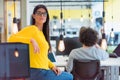 Young American business woman standing  and smiling.  Happy successful business leader posing while her team in background Royalty Free Stock Photo