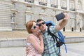 Young American couple enjoying Spain holiday trip taking selfie photo self portrait with mobile phone Royalty Free Stock Photo