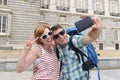 Young American couple enjoying Spain holiday trip taking selfie photo self portrait with mobile phone Royalty Free Stock Photo