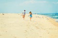 Young American Couple running, relaxing on the beach in New Jersey, USA Royalty Free Stock Photo