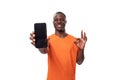 young american man experiencing joy and happiness demonstrating smartphone screen with mockup on white background with Royalty Free Stock Photo