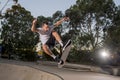 Man practicing radical skate board jumping and enjoying tricks and stunts in concrete half pipe skating track in sport and healthy Royalty Free Stock Photo