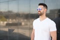 Young american man smiling happy with sunglasses portrait outdoor