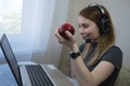 young american teen girl wear headphones video calling on laptop. pretty woman student looking at computer screen watching webinar Royalty Free Stock Photo