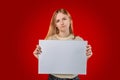 Sad woman hand holding white blank paper  on red studio background with clipping path Royalty Free Stock Photo