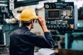 Young American worker intend to work in a heavy industrial factory looking and control machine in production line Royalty Free Stock Photo