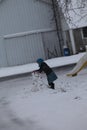 Young Amish girl building a snowman