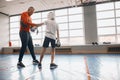 Young amn and ittle boy trying on new boxing gloves Royalty Free Stock Photo