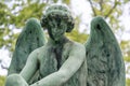 Young angel sculpture on a tomb at a graveyard Royalty Free Stock Photo
