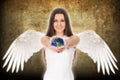 Young angel woman holding Earth in hands