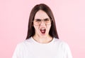 Young anger woman screaming loudly over pink background Royalty Free Stock Photo