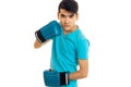 Young angry brunette man in blue boxing gloves practicing isolated on white background Royalty Free Stock Photo