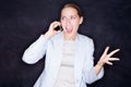 Young angry business woman shouting over the phone. Aggressive young business woman shouting over a cellphone Royalty Free Stock Photo