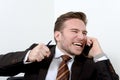 Young angry businessman breaking a pencil with teeth