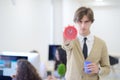 Young angry businessman pointing his watch as concept of arrive late at the work