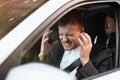 Young angry businessman sitts in his car looks desperate after hard day at workplace, stressfull working conditions concept Royalty Free Stock Photo