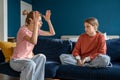 Young angry emotional mother screaming at troubled teen daughter at home Royalty Free Stock Photo