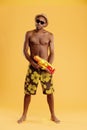 Young angry handsome black man holding water gun Royalty Free Stock Photo