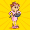 Young angry housewife in hair curlers and a dressing gown holding a frying pan