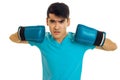 Young angry man in blue shirt practicing boxing in gloves isolated on white background Royalty Free Stock Photo