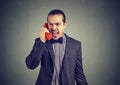 Young angry man yelling on the telephone Royalty Free Stock Photo