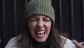 Young angry woman shouting arguing feeling betrayed, cheated and frustrated. Close up female looking at camera with negative