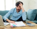 Angry man paying bills as home with laptop and calculator Royalty Free Stock Photo