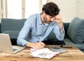 Angry man paying bills as home with laptop and calculator Royalty Free Stock Photo