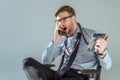 Young annoyed businessman yelling while talking on phone Royalty Free Stock Photo