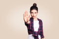 Young annoyed woman with bad attitude making stop gesture with her palm outward, saying no, expressing denial or restriction. Royalty Free Stock Photo