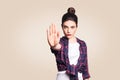 Young annoyed woman with bad attitude making stop gesture with her palm outward, saying no, expressing denial or restriction. Royalty Free Stock Photo