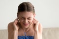 Young annoyed woman sticking fingers in ears, not listening nois Royalty Free Stock Photo