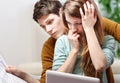 Young anxious couple consults their bank account Royalty Free Stock Photo