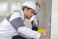 Young apprentice filling wall Royalty Free Stock Photo