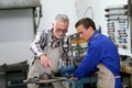 Young apprentice in ironworks with monitor Royalty Free Stock Photo