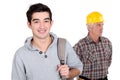 Young apprentice posing next to craftsman Royalty Free Stock Photo