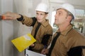 young apprentice with professional plasterer