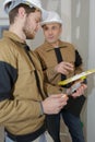 young apprentice with professional plasterer