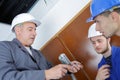 Young apprentices with electrician professional