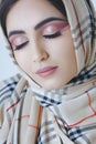 Young arab girl with oriental makeup in hijab