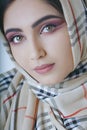 Young arab girl with oriental makeup in hijab