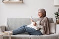 Young Arab Housewife Relaxing At Home With Smartphone And Coffee Royalty Free Stock Photo