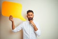 Young arab indian hispanic man holding speech bubble over isolated white background serious face thinking about question, very Royalty Free Stock Photo