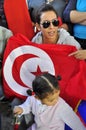 Young arab lady with red flag and little girl