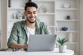 Young arab male writer working on laptop computer at home office Royalty Free Stock Photo