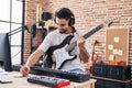 Young arab man artist compose song playing electrical guitar at music studio