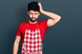 Young arab man with beard wearing cook apron confuse and wonder about question